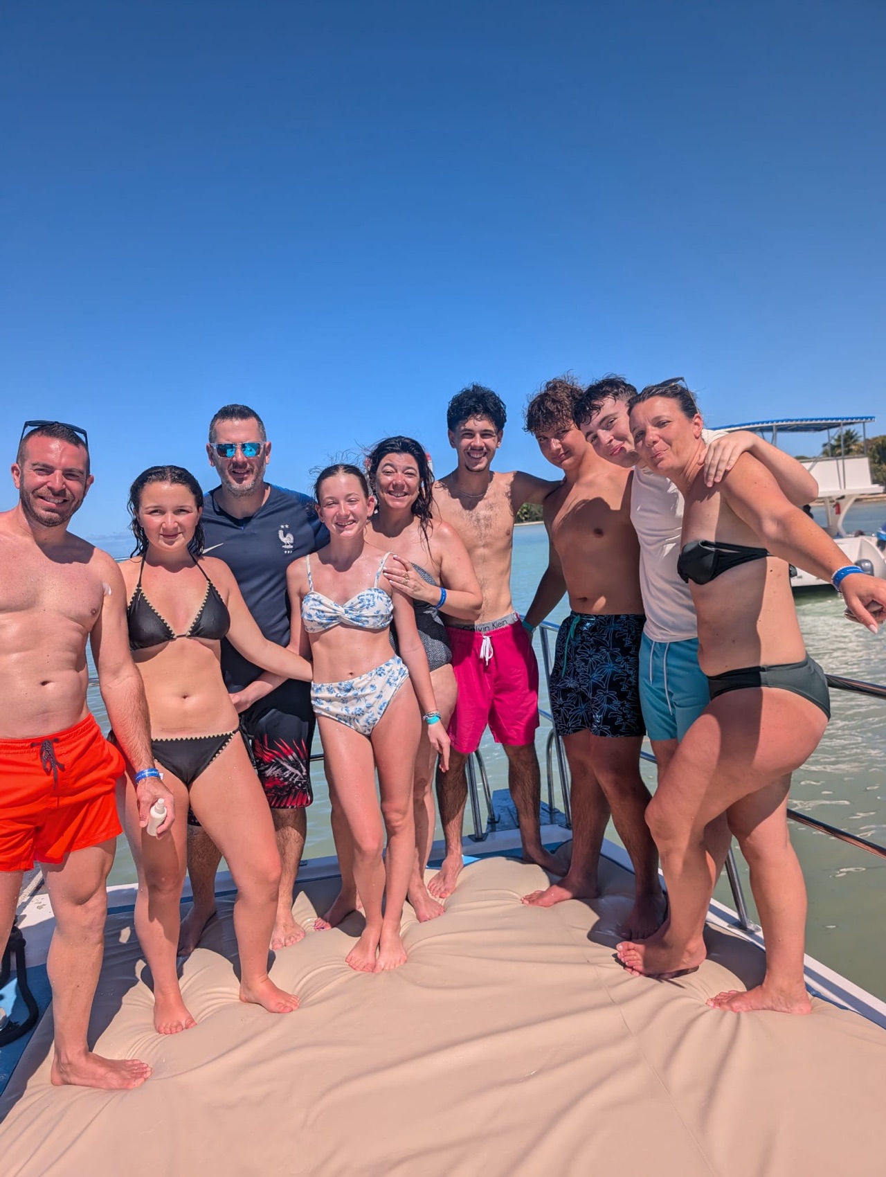 Family group smiling together on a private boat